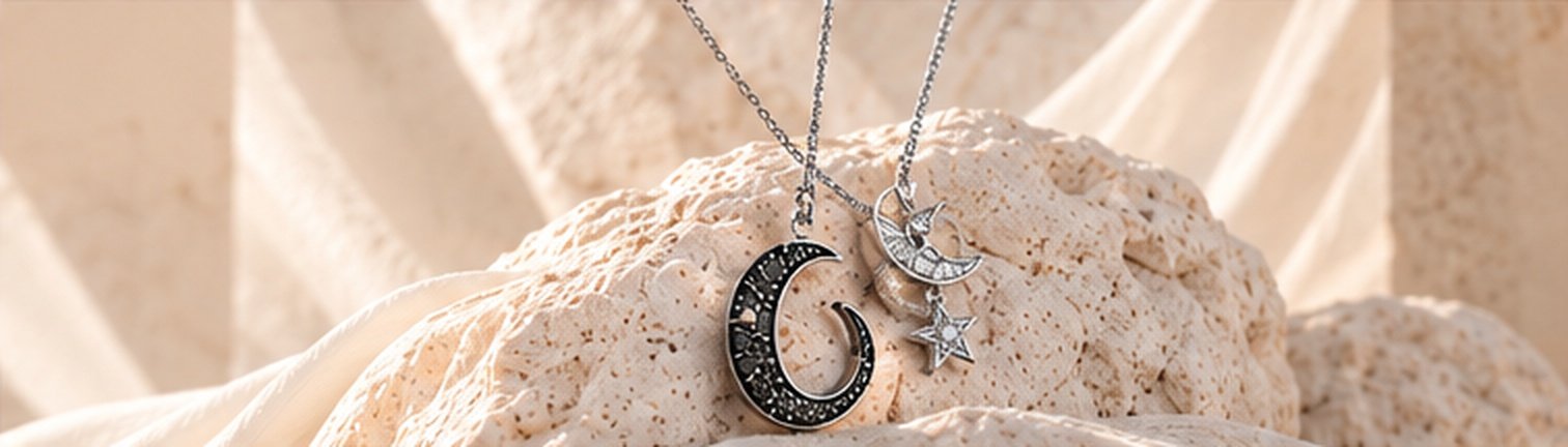 Crescent moon necklace with a star charm on textured stone